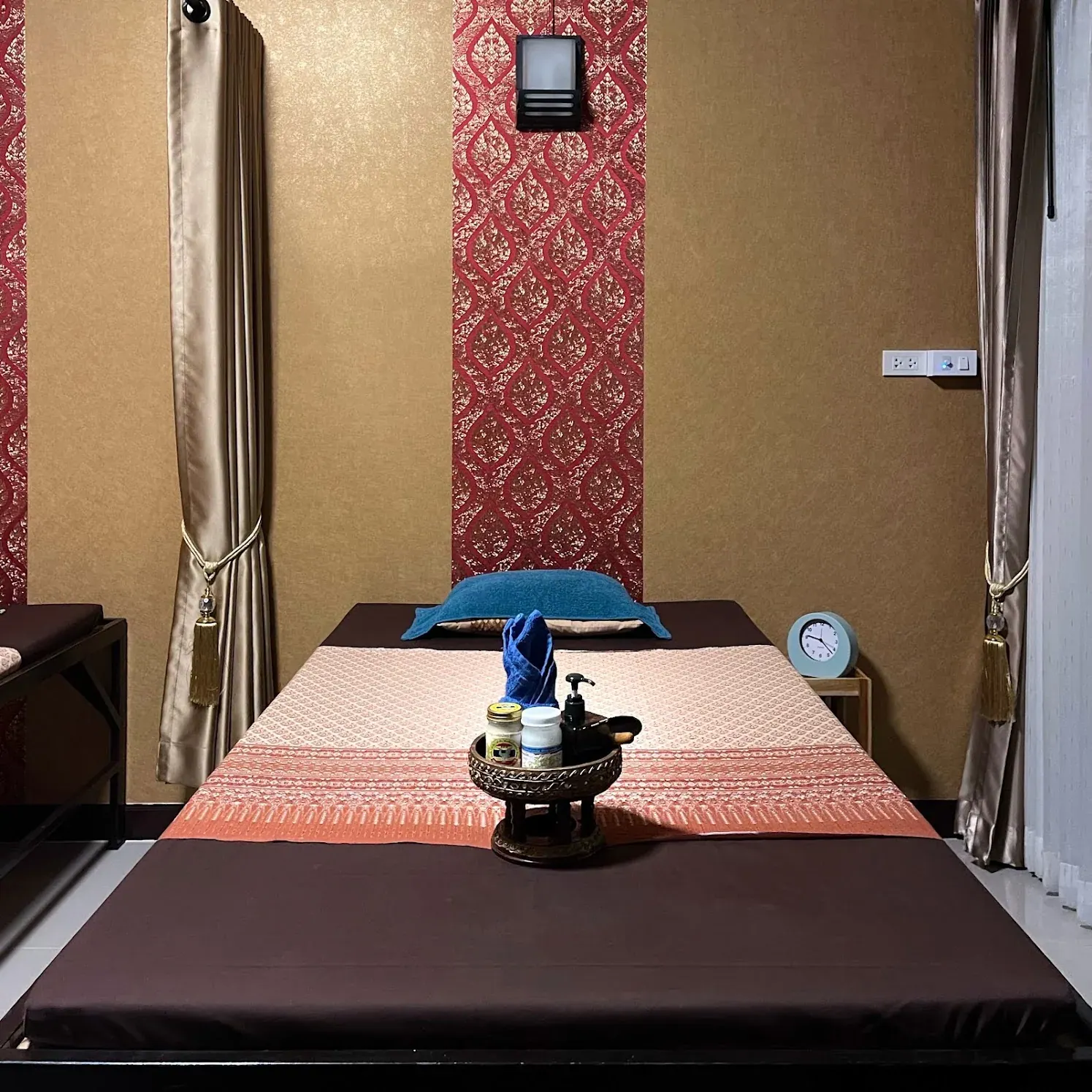A massage bed prepared with towels and treatment items